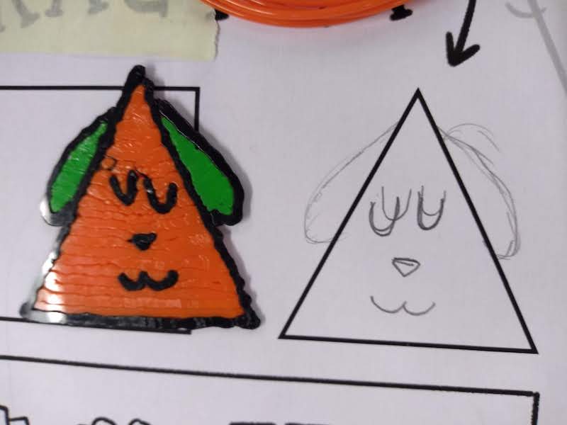 Orange triangle-shaped dog make with a 3D pen